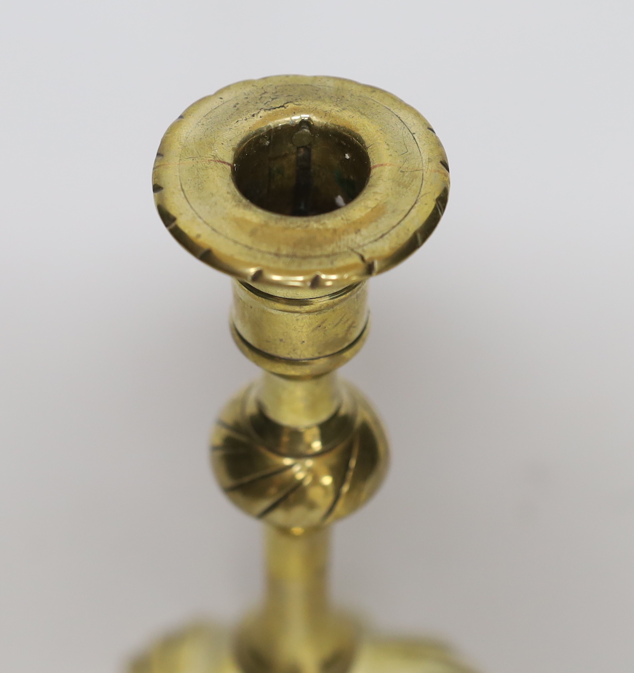 A mid 18th century swirl base brass candlestick, 21cm